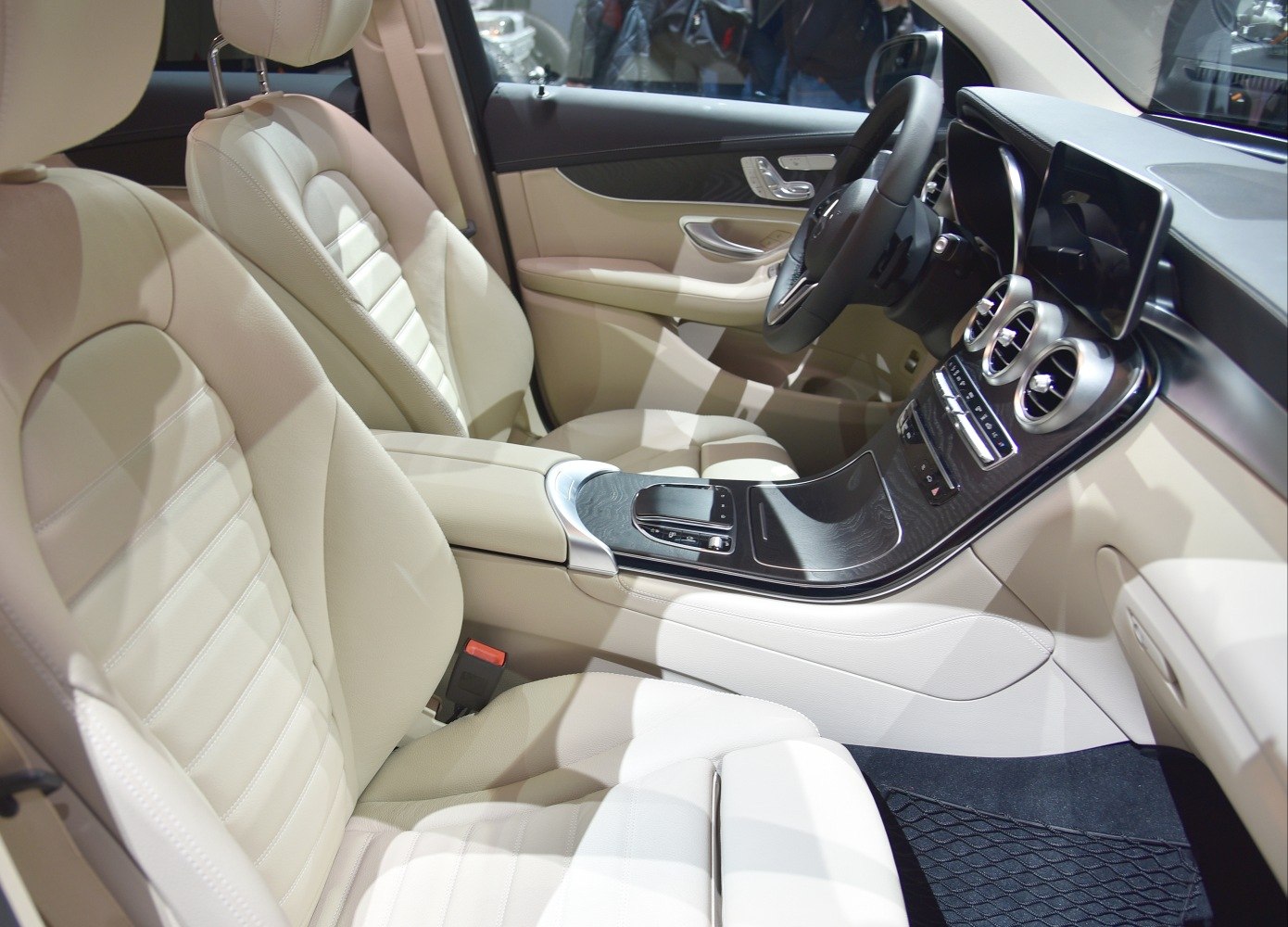 Beige leather seats and modern dashboard with touchscreen and circular air vents