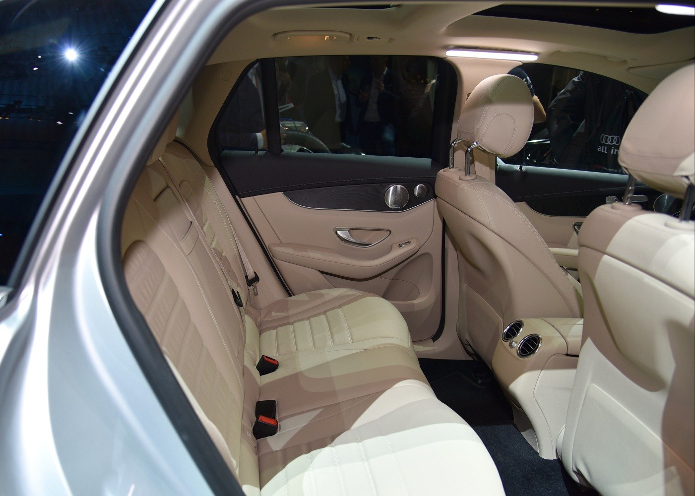 Beige leather rear seats with door panel and air vents