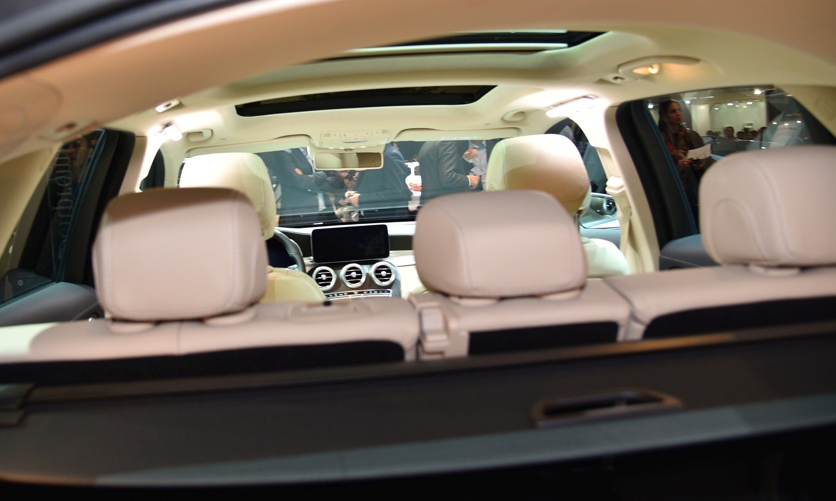 Light-colored leather seats and panoramic sunroof in spacious SUV interior