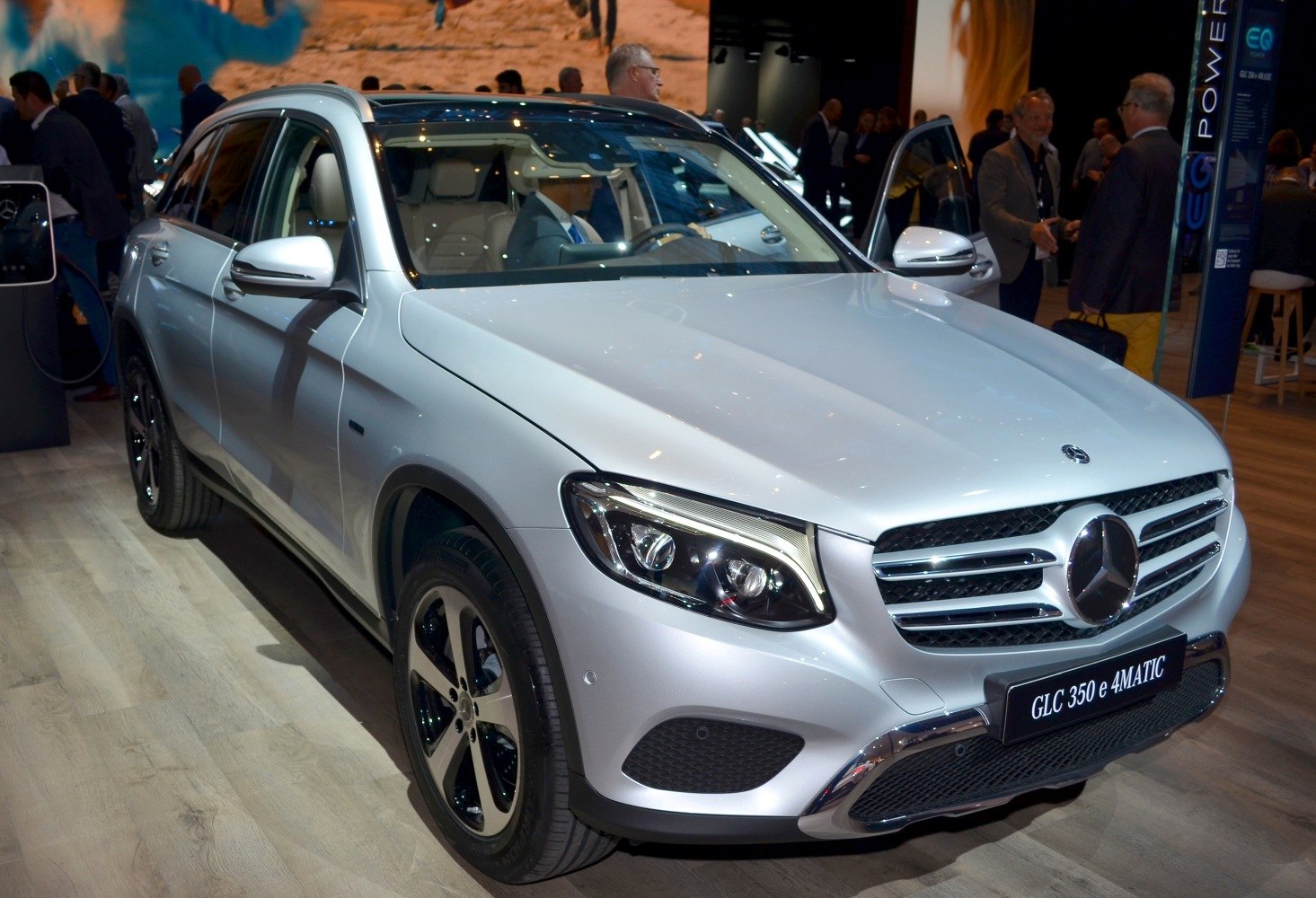 Front and side view of a silver SUV with LED headlights and alloy wheels