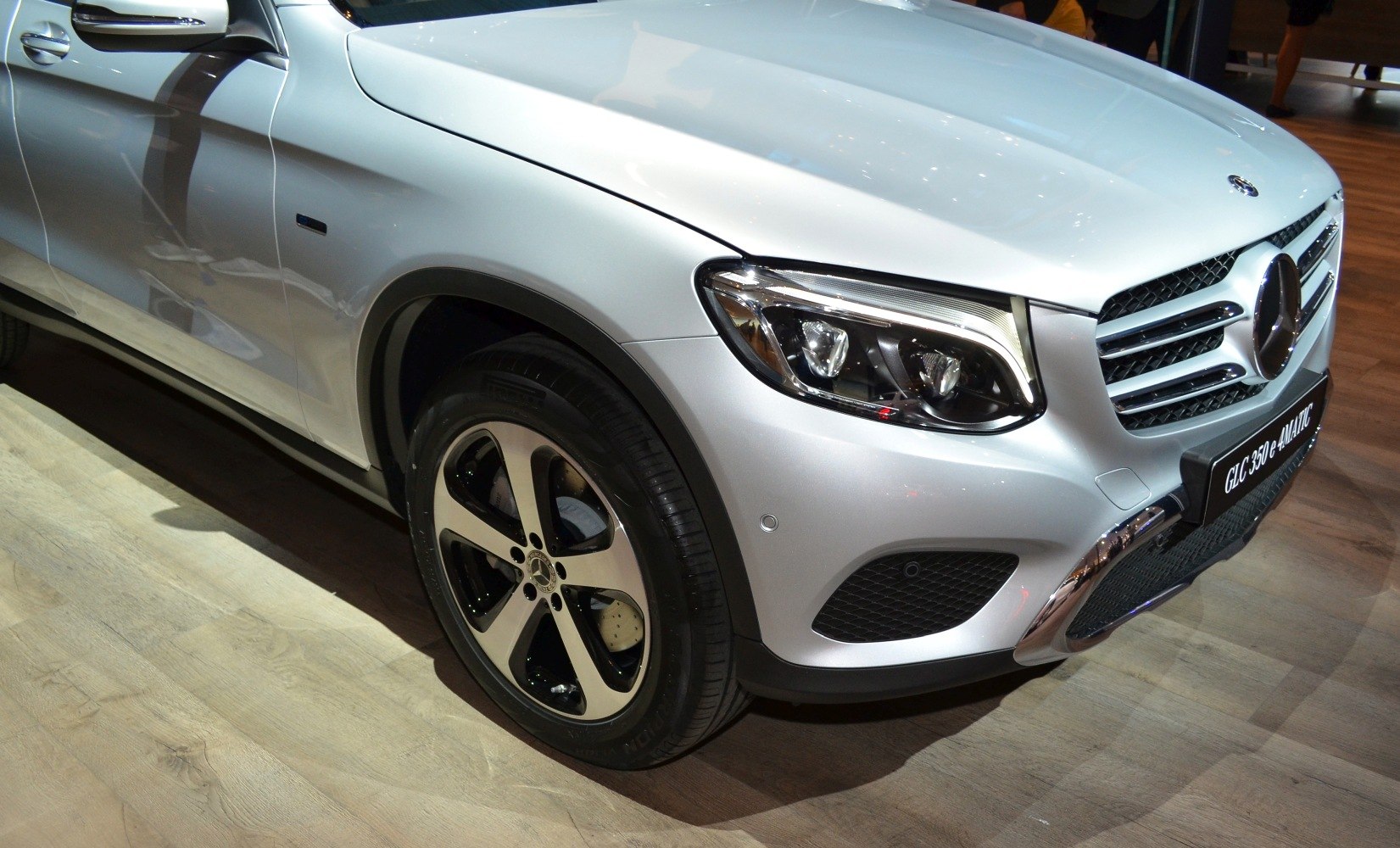Close-up of front headlights and alloy wheel with tire
