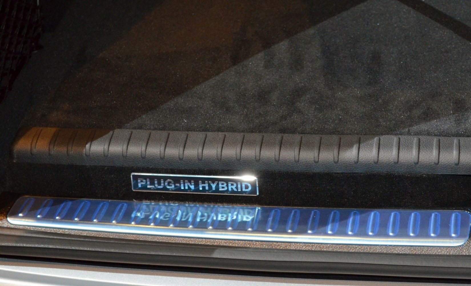 Plug-in hybrid badge and illuminated door sill plate interior detail