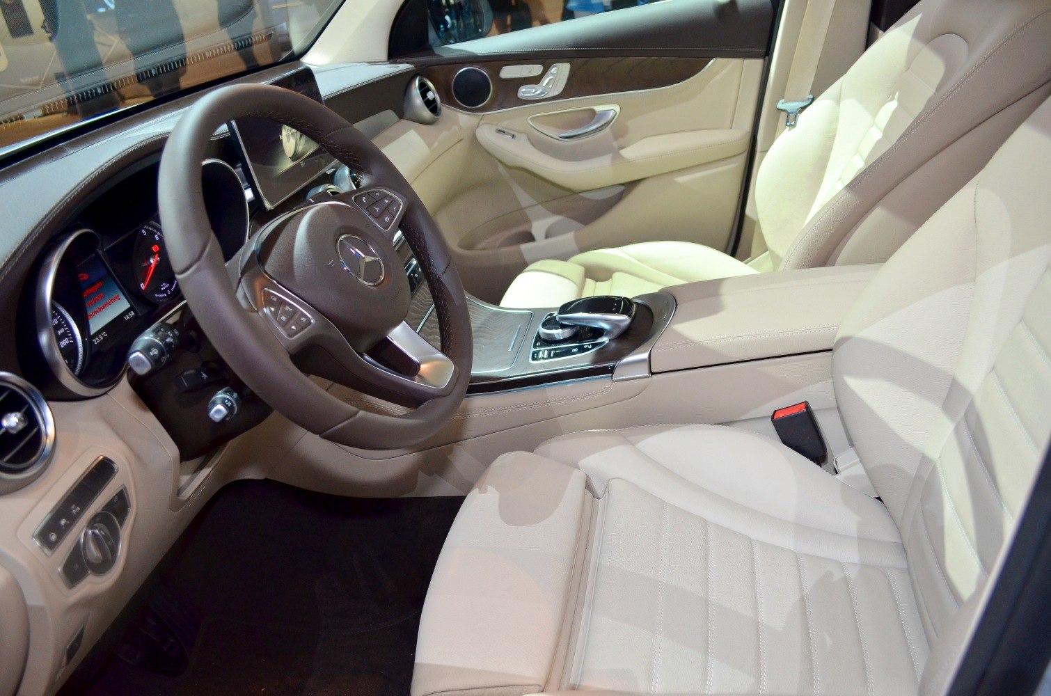 Luxury beige leather seats and modern dashboard with advanced steering wheel controls.