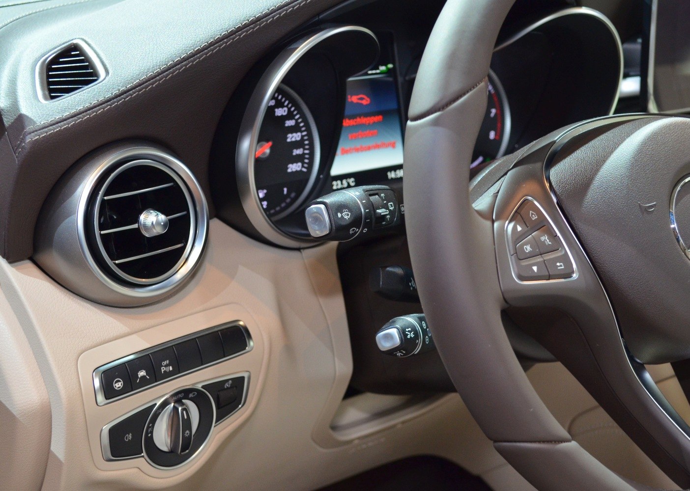 Dashboard air vent, steering wheel, and control stalks close-up