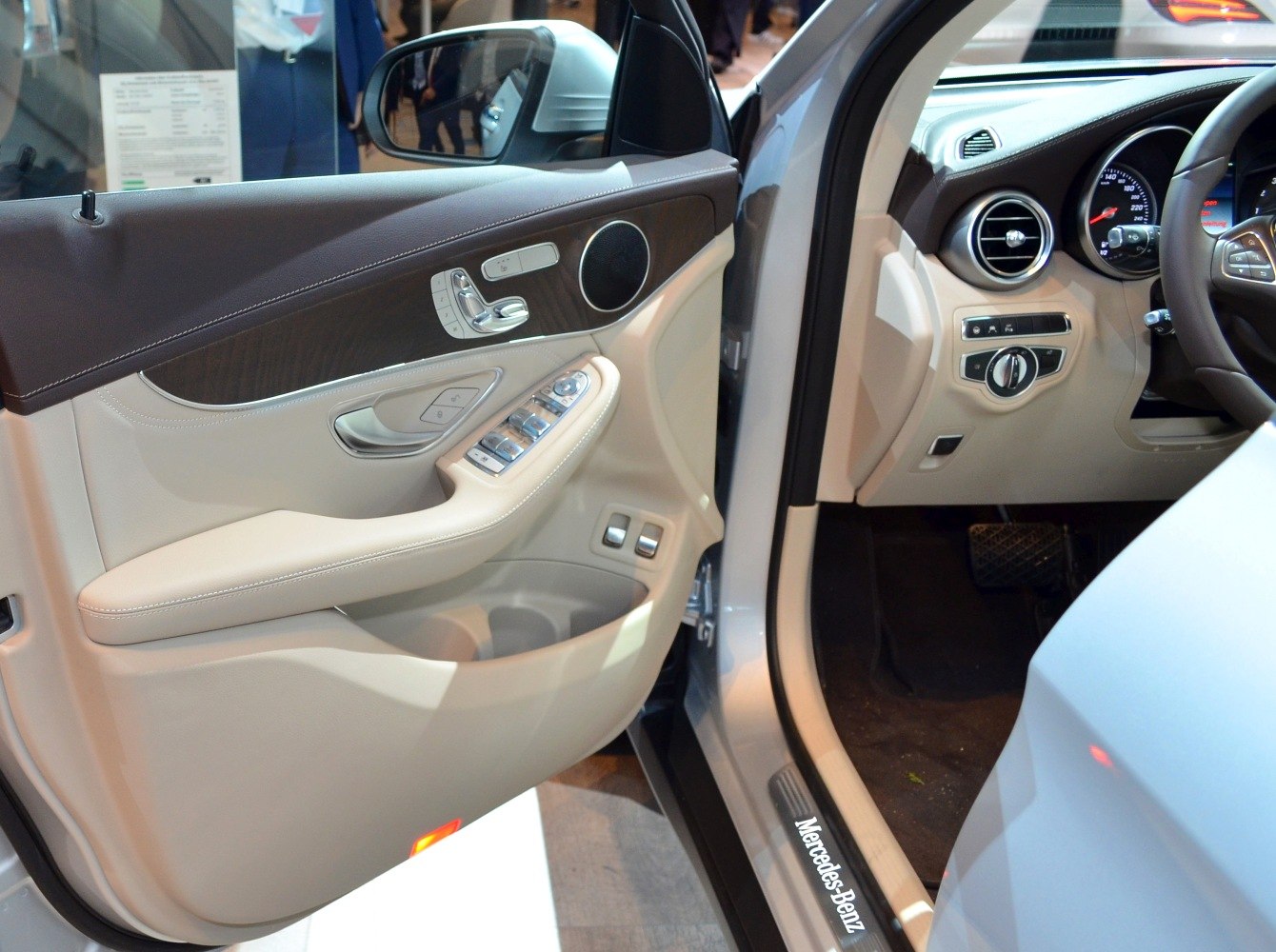 Luxury SUV door panel with controls and speaker