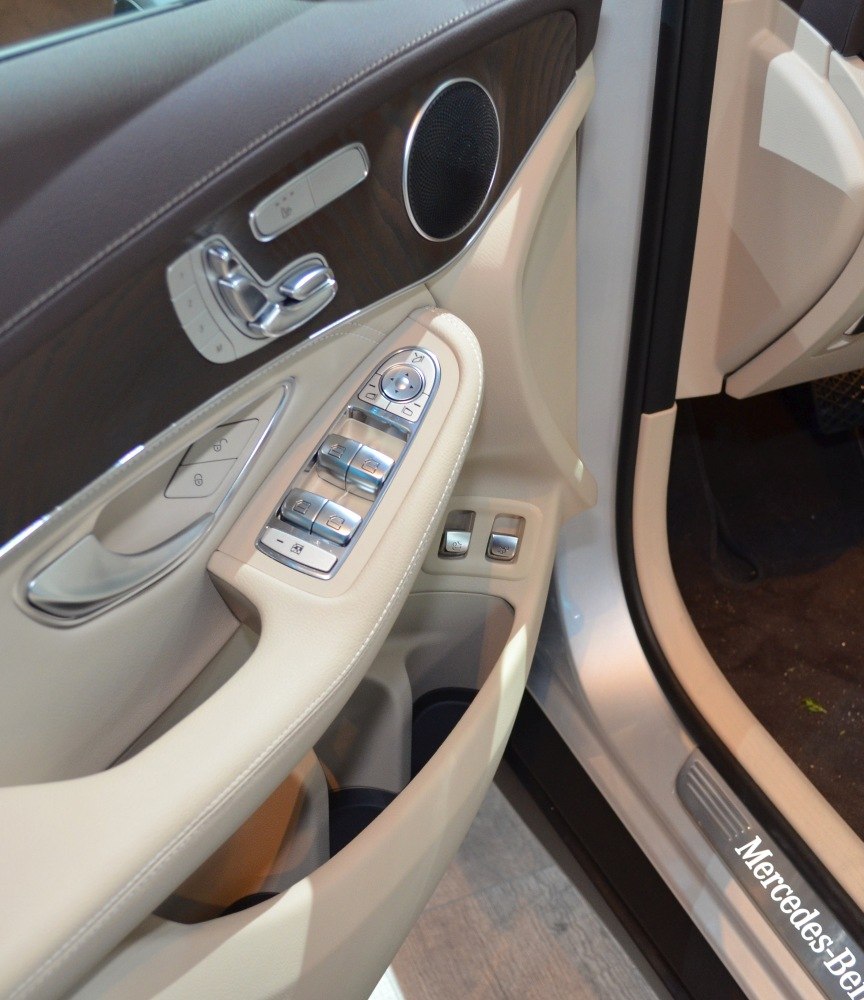 Driver side interior door panel with controls and speaker
