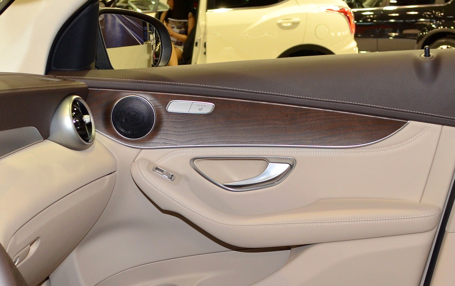 Luxury interior door panel with wood trim and metal accents