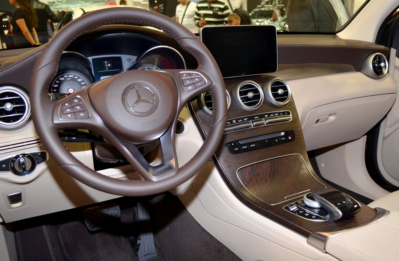 Luxury steering wheel and modern dashboard with wood trim and infotainment screen