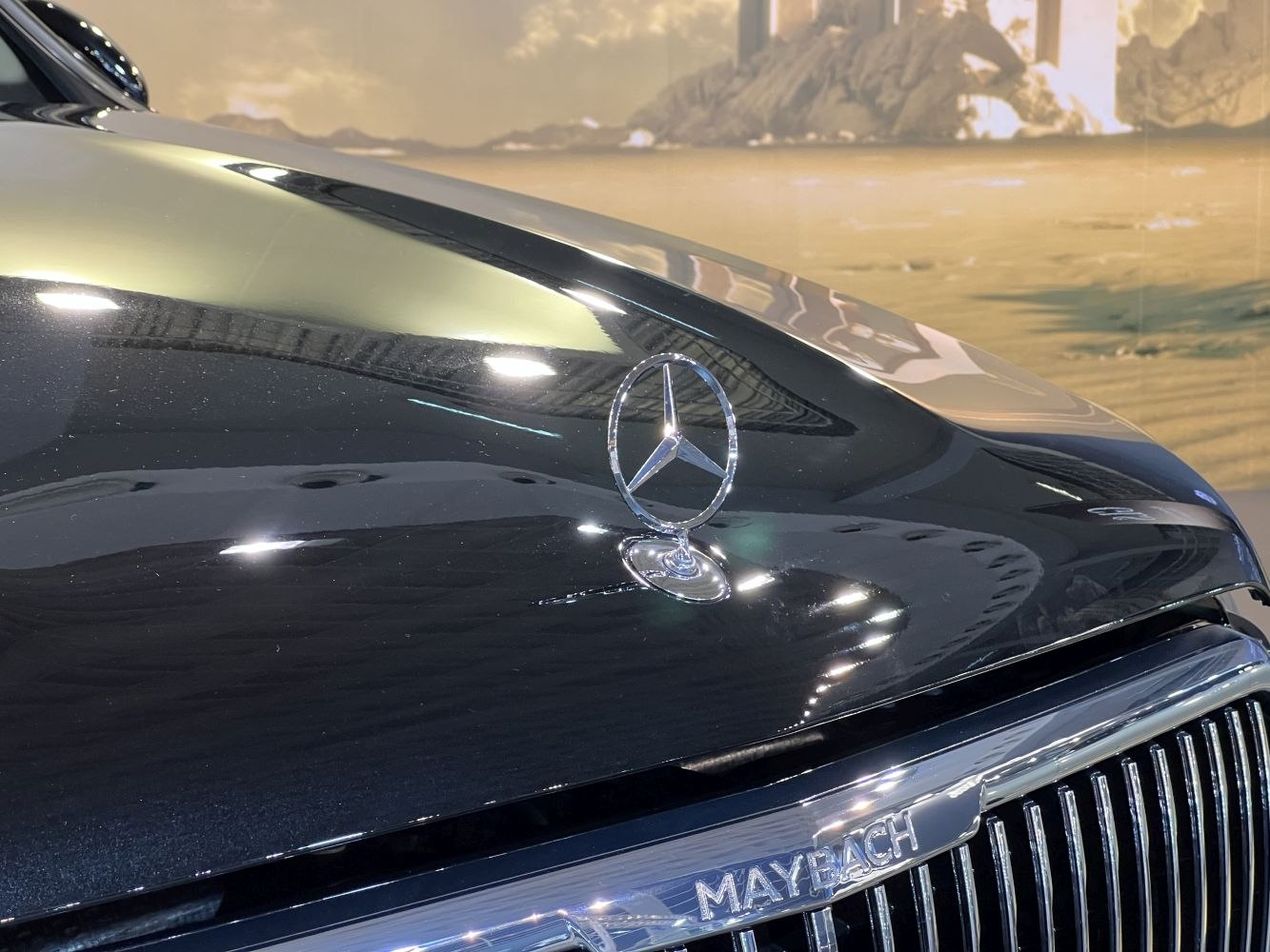 Close-up of Mercedes-Benz star hood emblem and Maybach grille