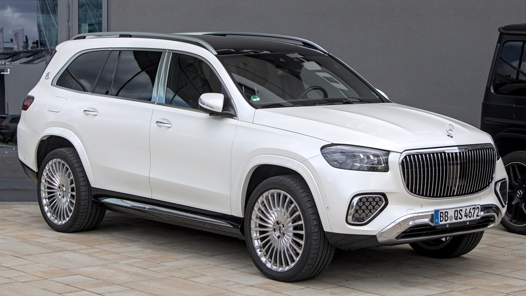 Luxury SUV with vertical grille and multi-spoke alloy wheels