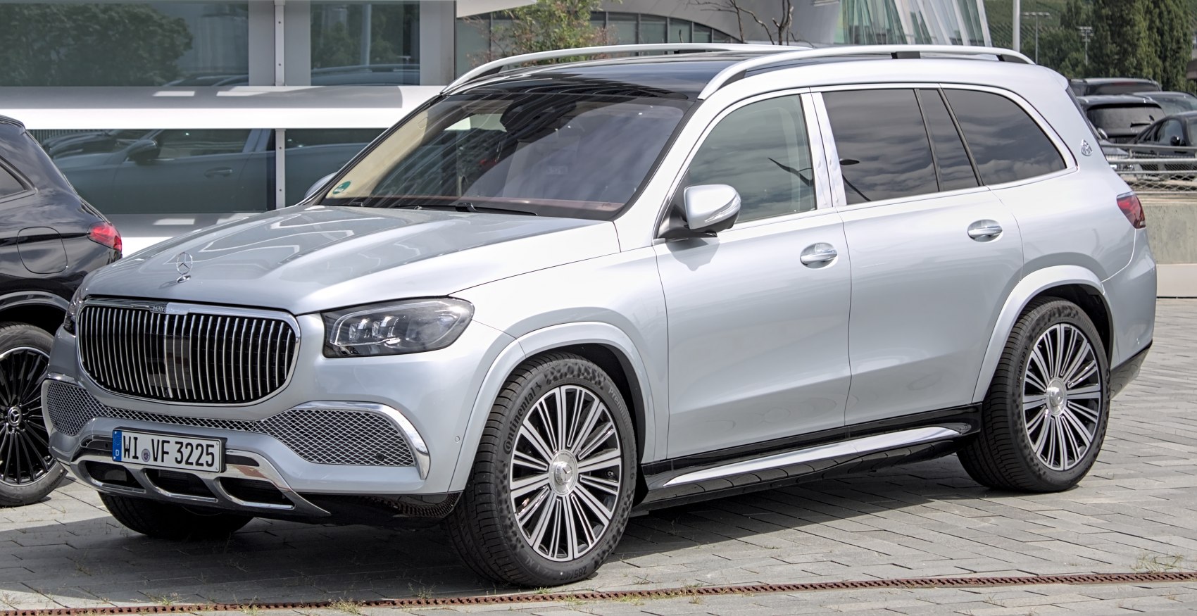 Vertical grille and large multi-spoke alloy wheels on a luxury SUV.