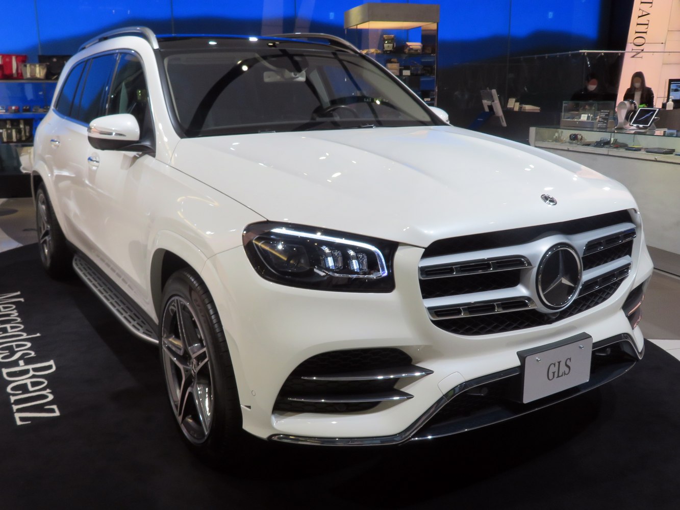 Modern luxury SUV front side view with LED headlights and chrome grille.