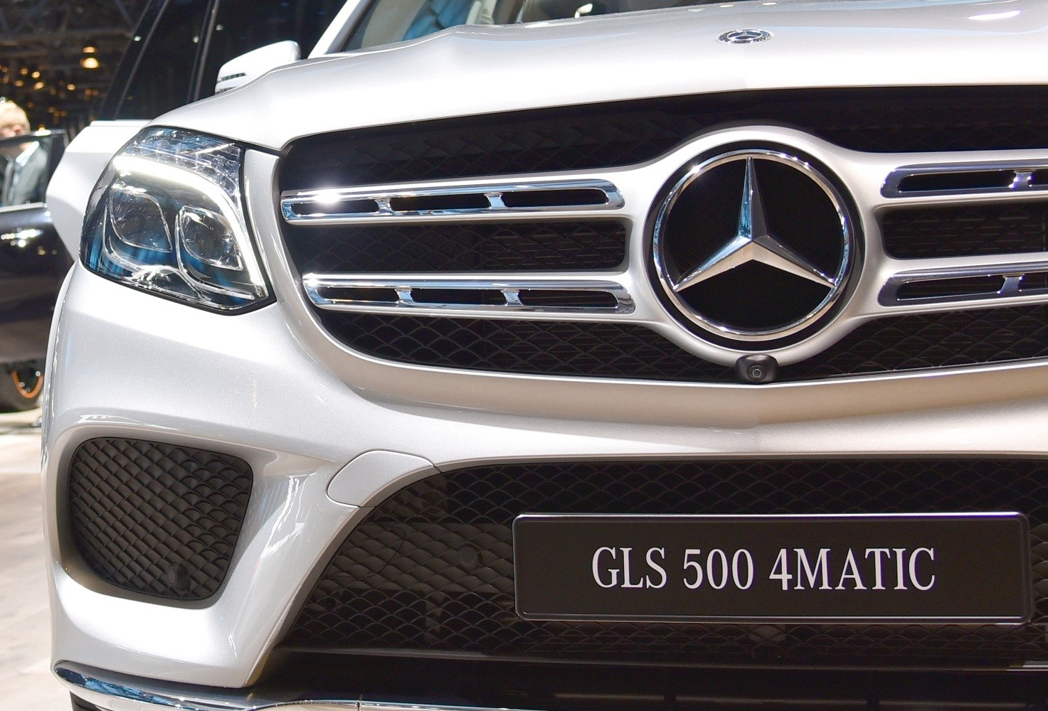 Close-up of luxury SUV front grille and headlight