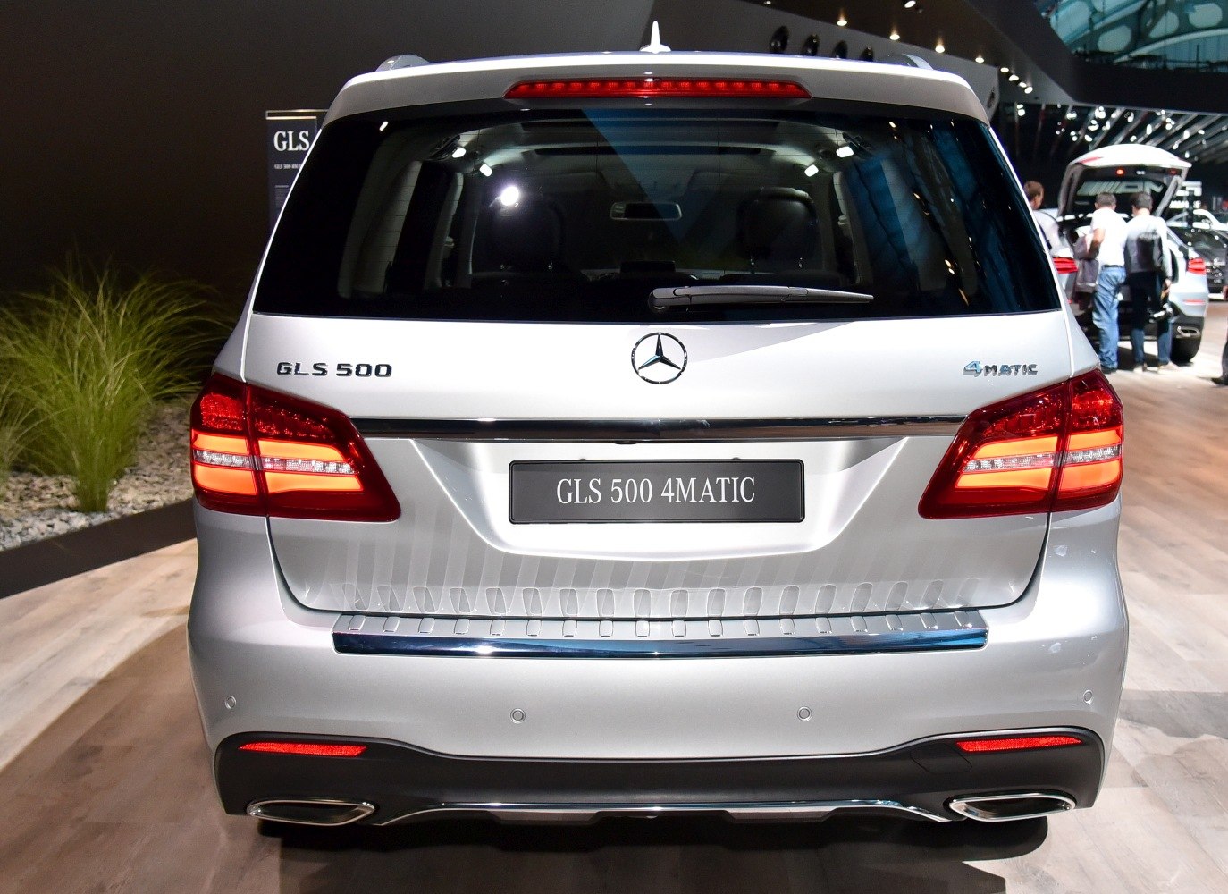 Silver luxury SUV rear with LED taillights and dual exhausts