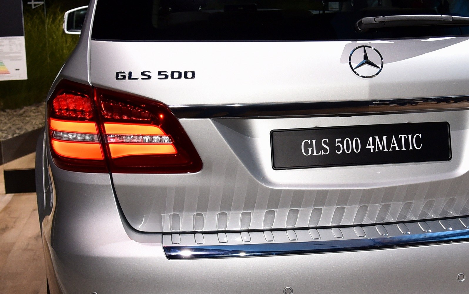Rear view with GLS 500 badges and illuminated taillights.