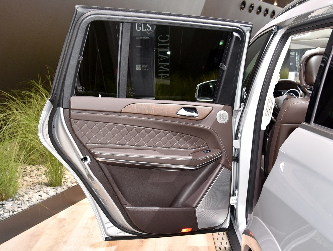 Quilted leather and wood trim on rear door with premium speaker