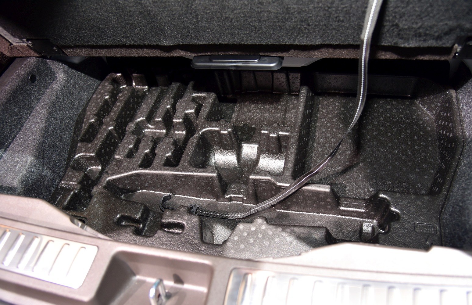 Trunk storage compartment with foam organizer liner