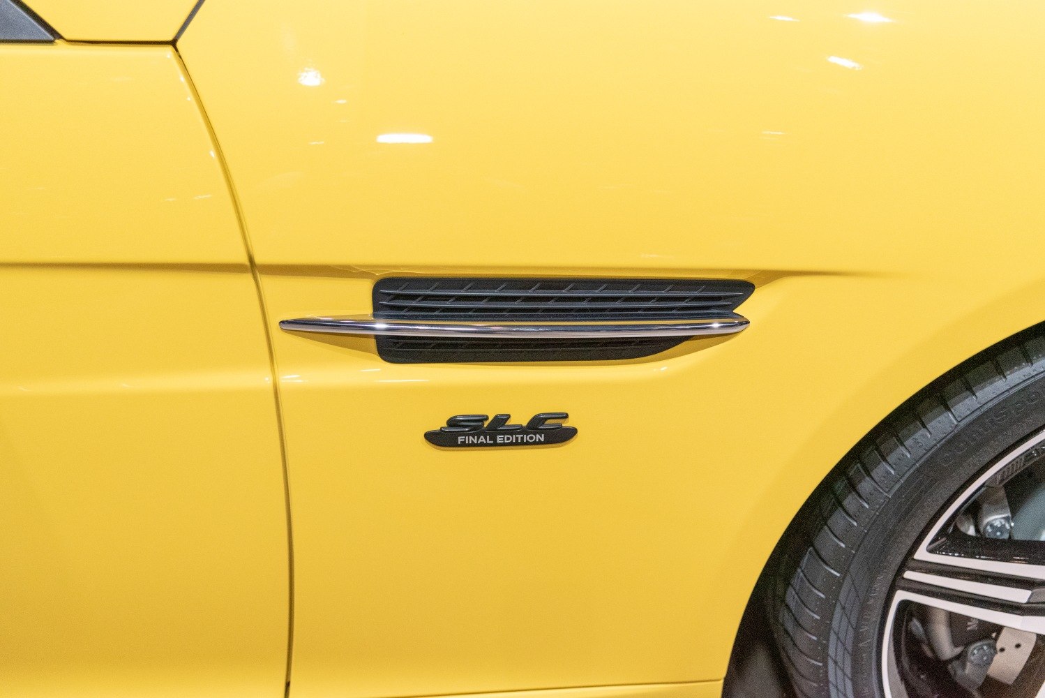 Close-up of side vent and final edition badge on yellow car panel
