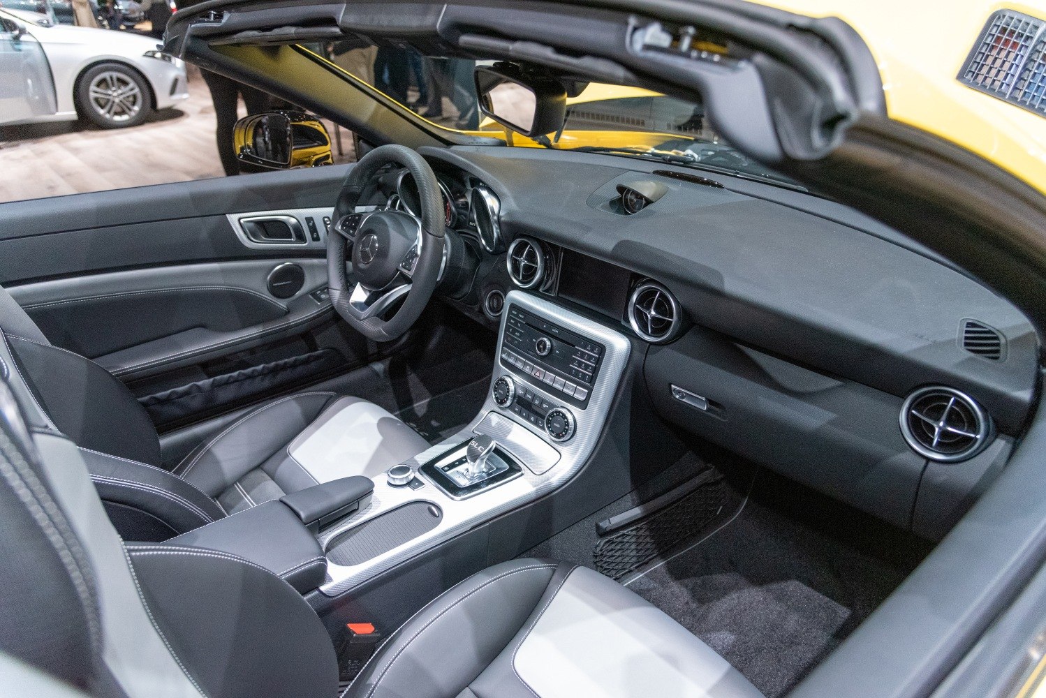 Dashboard, steering wheel, center console, and front seats interior view