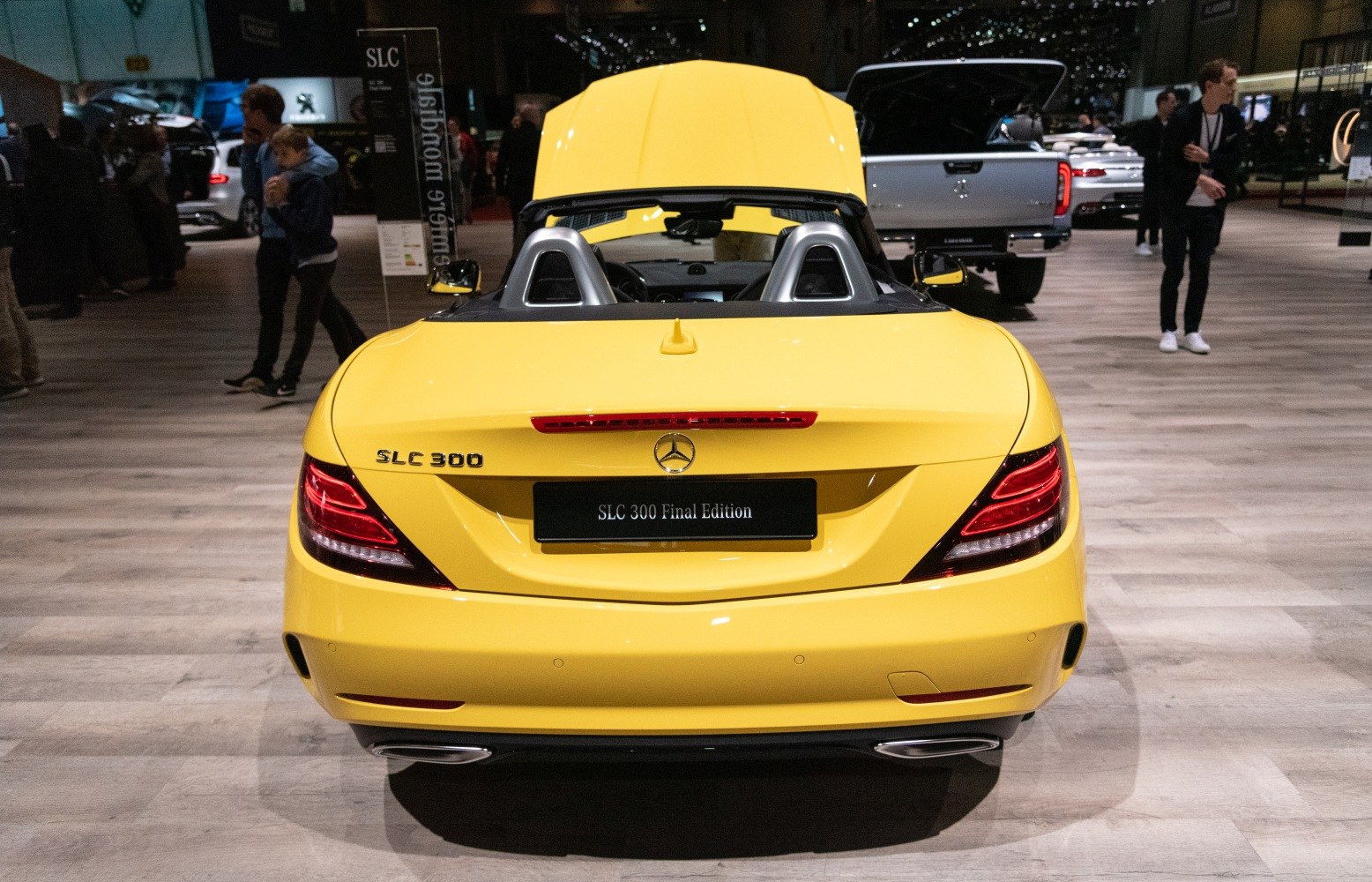 Bright yellow rear convertible with dual exhaust and illuminated tail lights