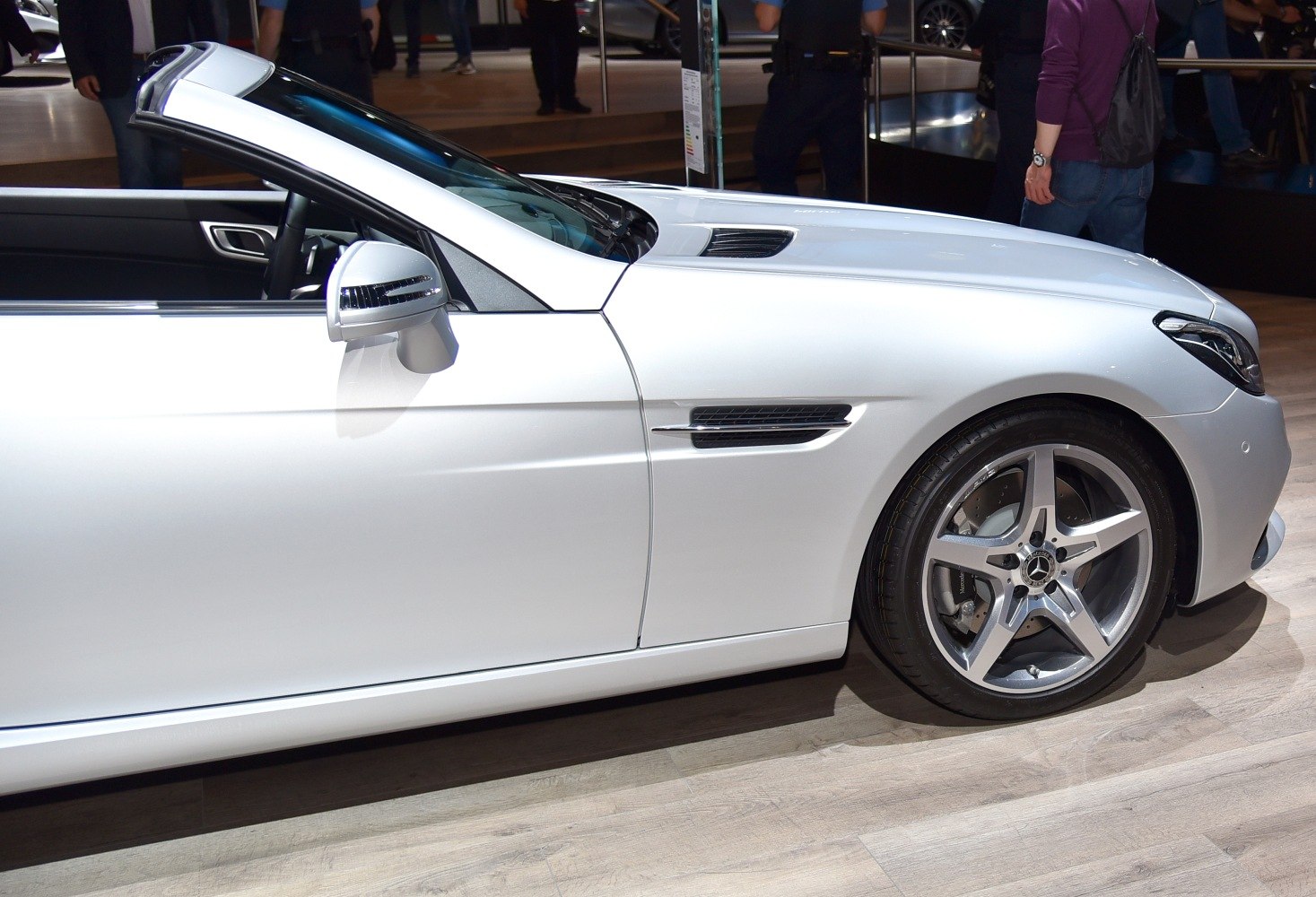 Front side close-up of convertible showing wheel and mirror