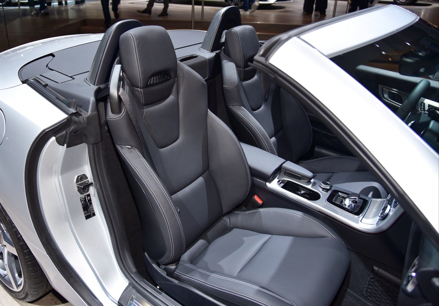 Black leather bucket seats with detailed stitching and center console in convertible interior