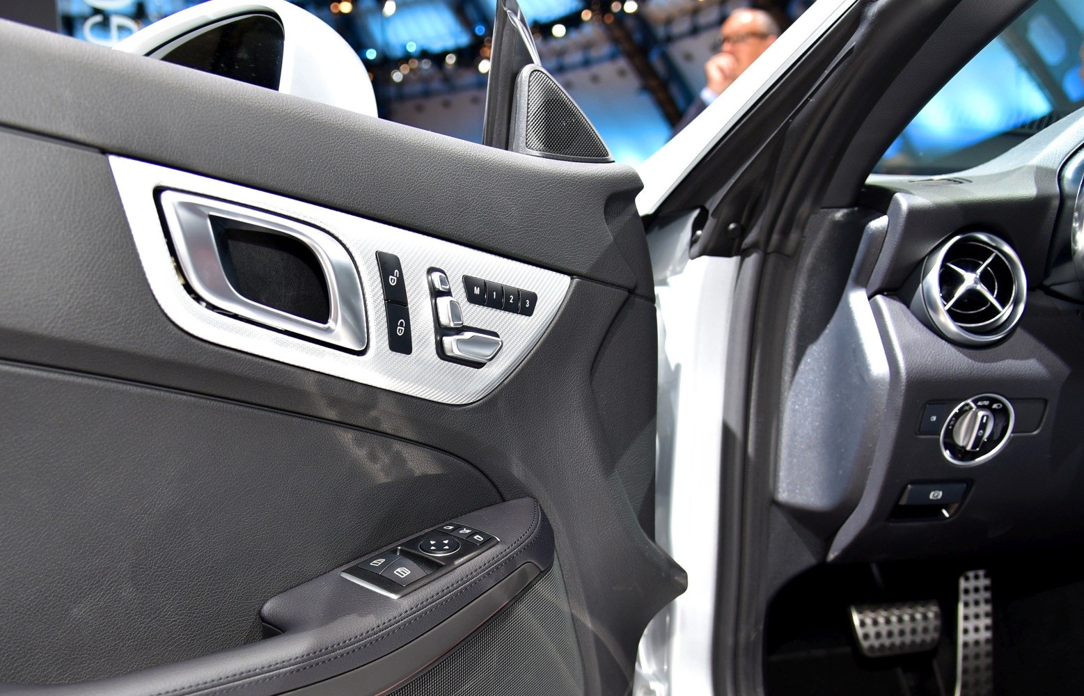 Driver door panel with seat adjustment and dashboard air vent