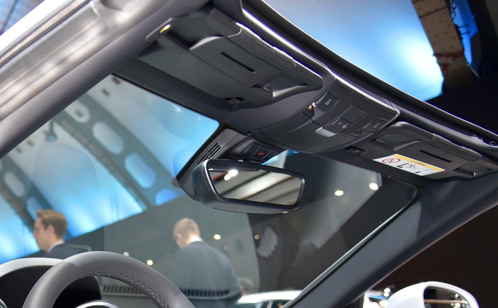 Interior rearview mirror and overhead control console with sun visors.