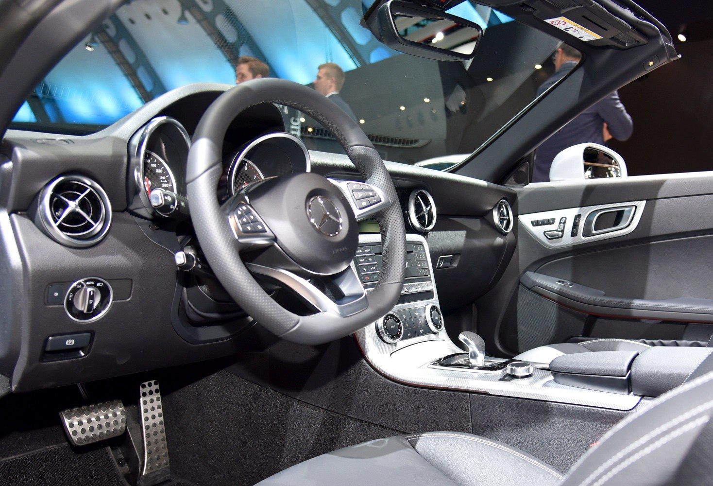 Dashboard and steering wheel with control buttons and circular air vents