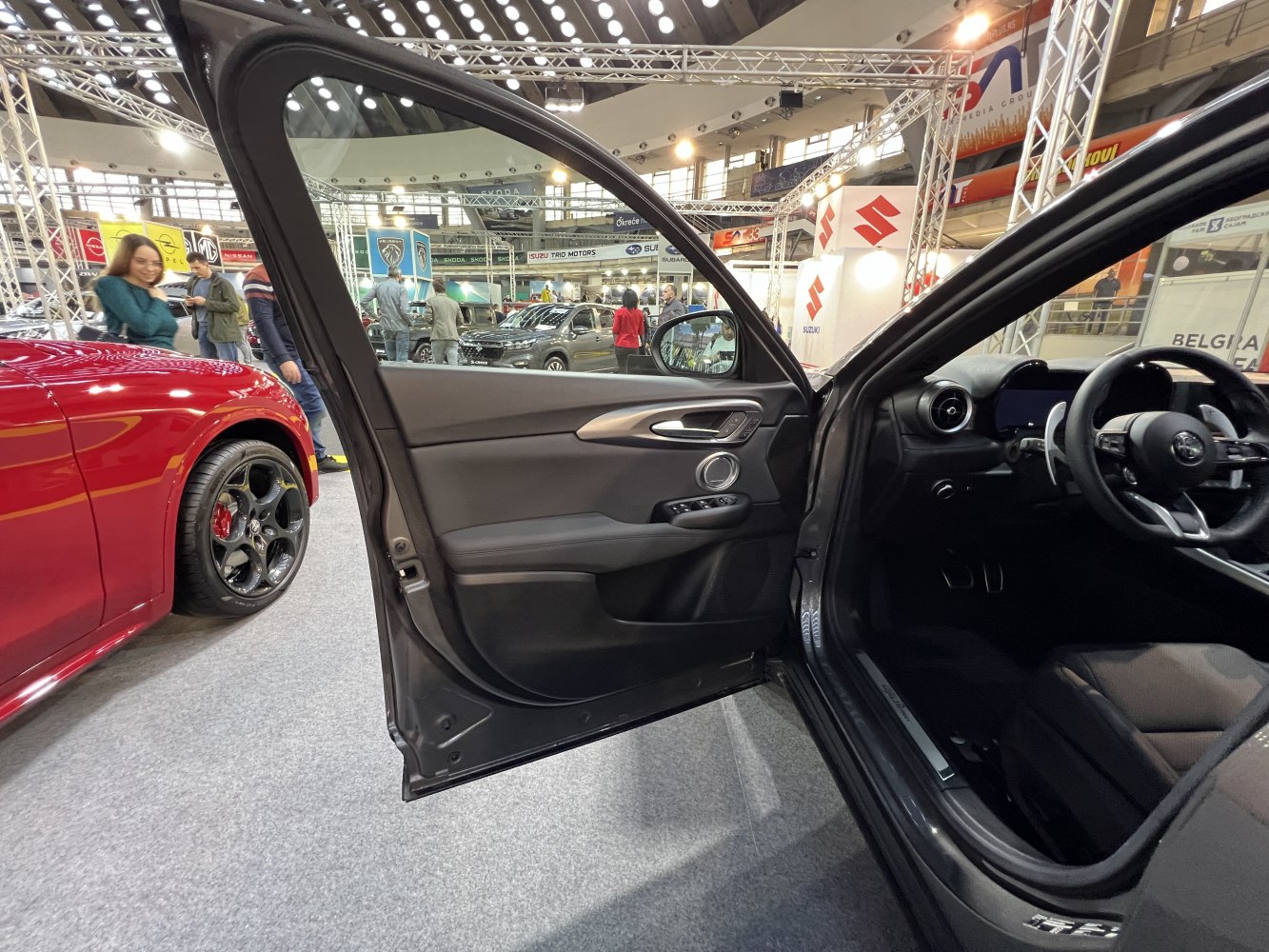 Interior door panel and dashboard of a modern vehicle with control buttons and steering wheel