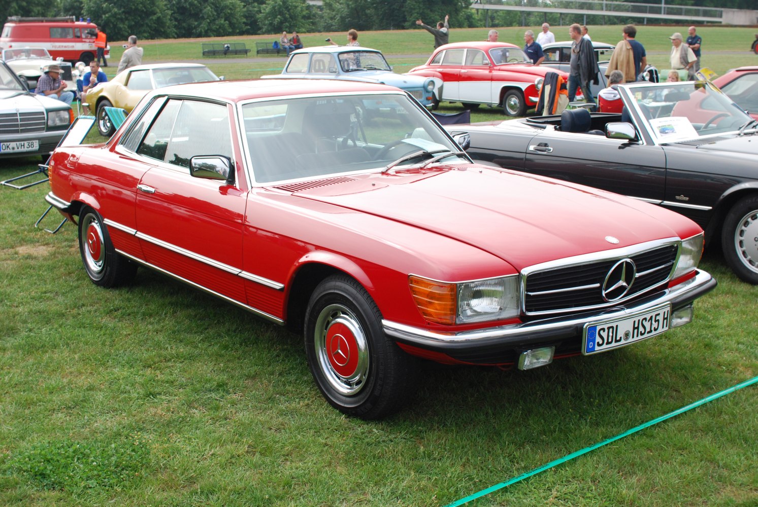 Red classic luxury coupe with chrome trim and vintage styling