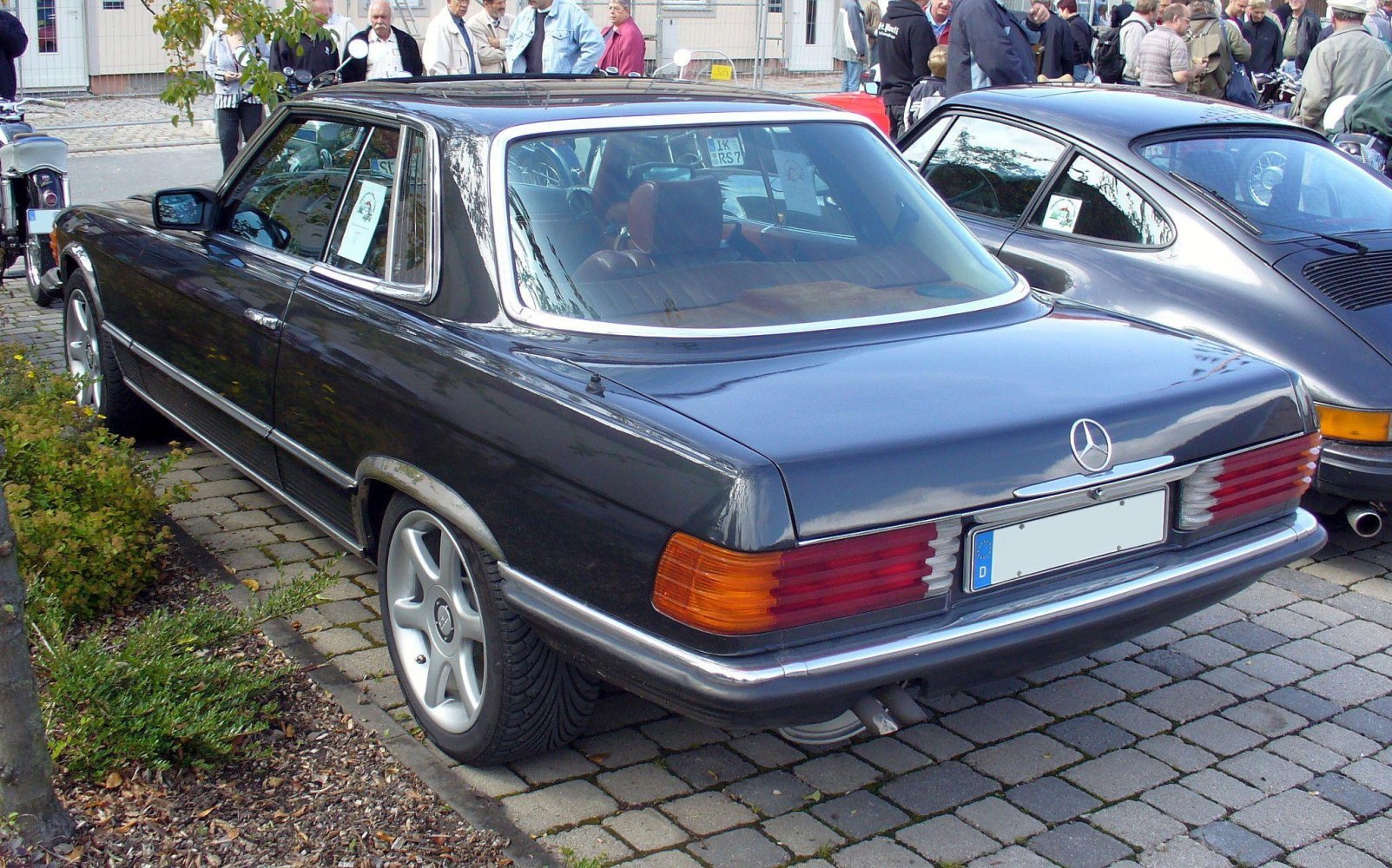 Rear-side view of a classic hardtop coupe with distinctive tail lights and alloy wheels.