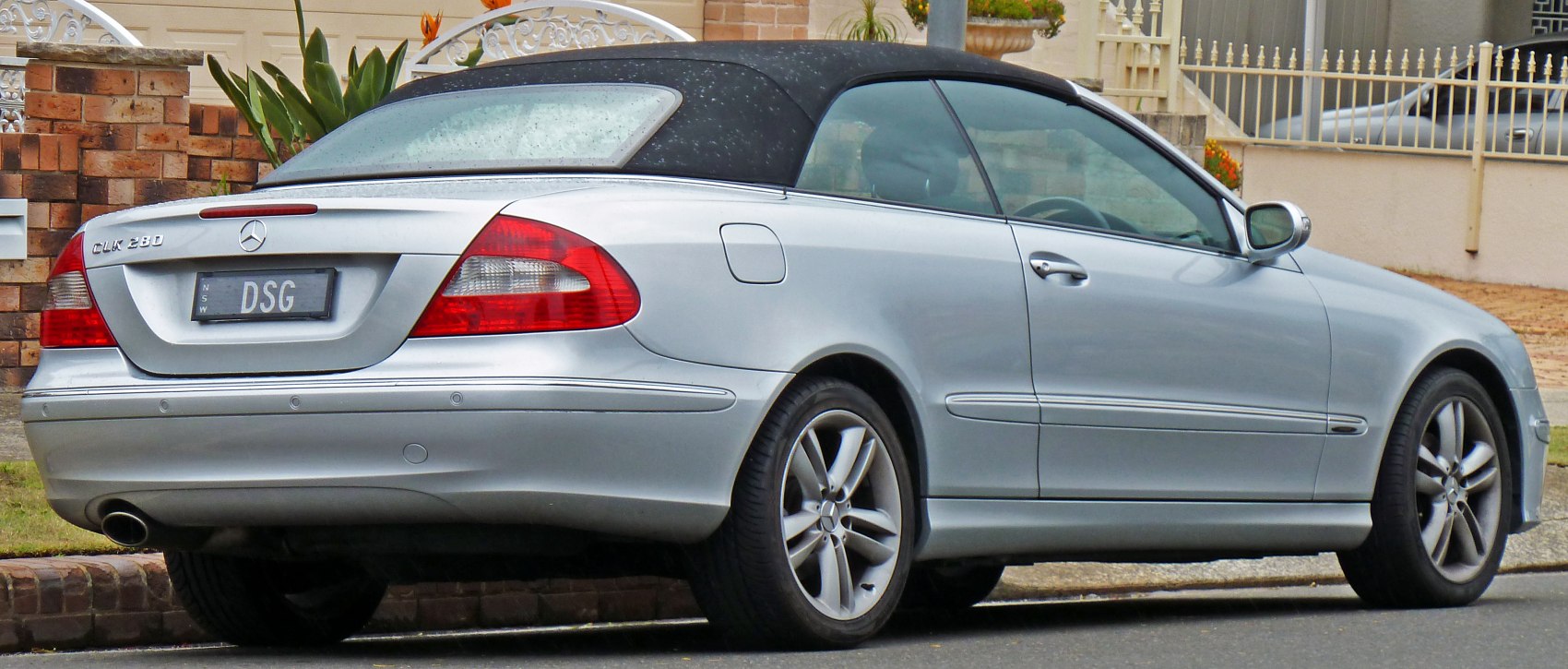 Silver convertible with soft top and distinctive rear design