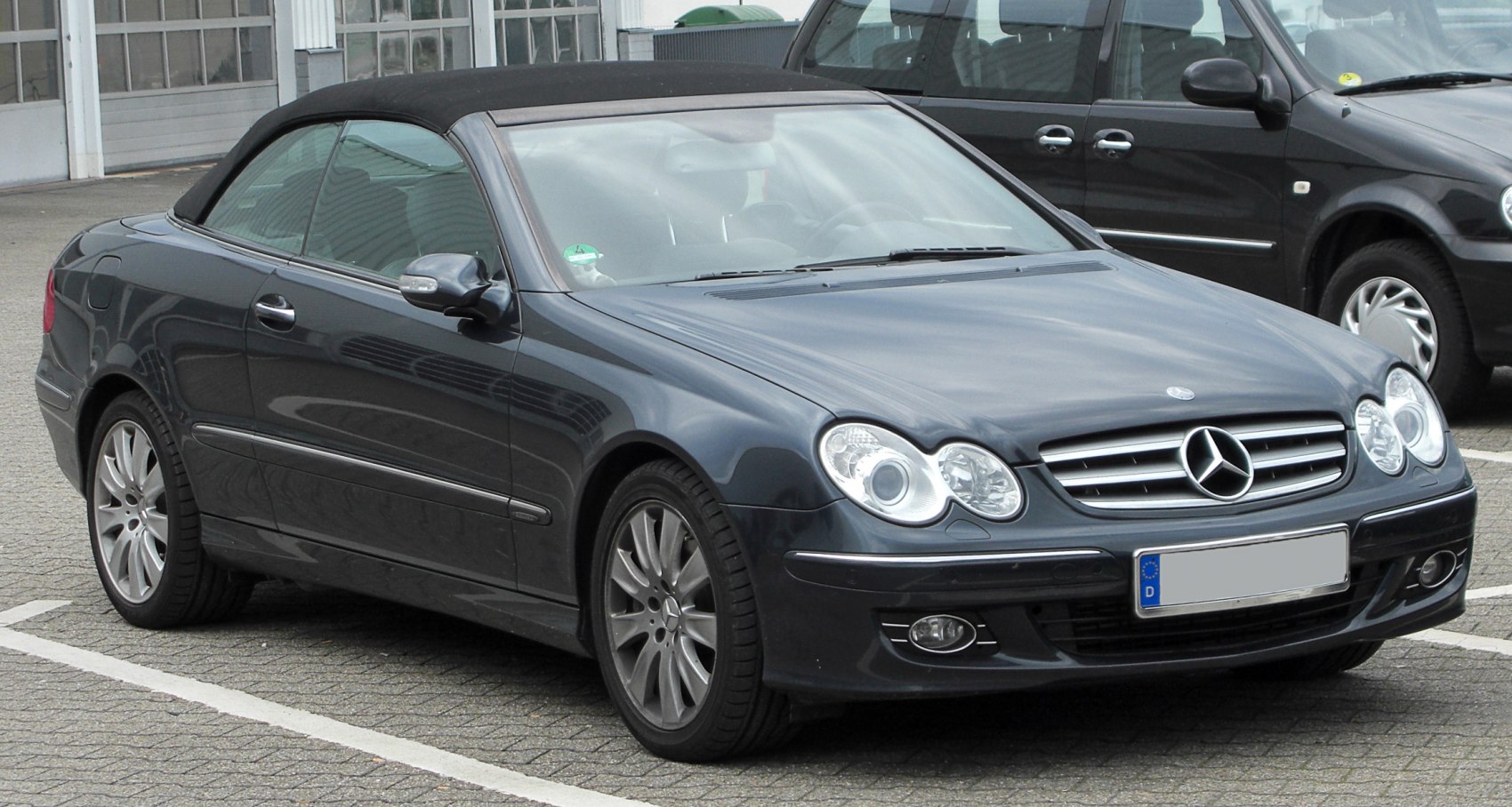 Convertible with dual round headlights and soft top roof