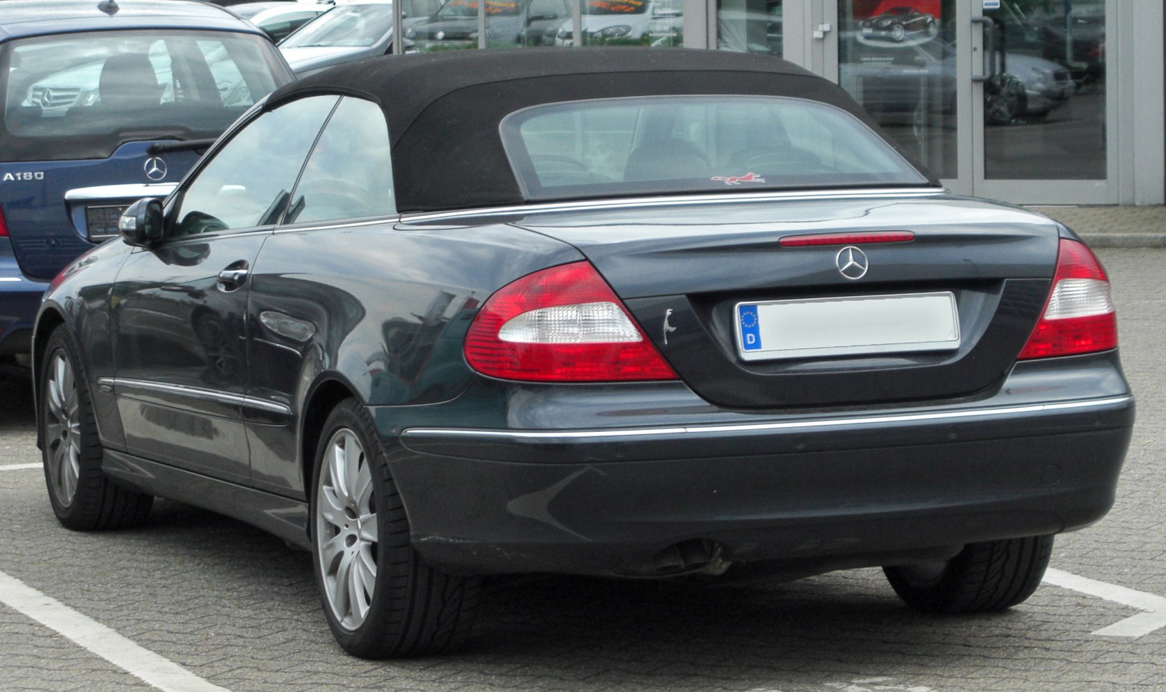 Rear view of a convertible with soft top and distinctive tail lights