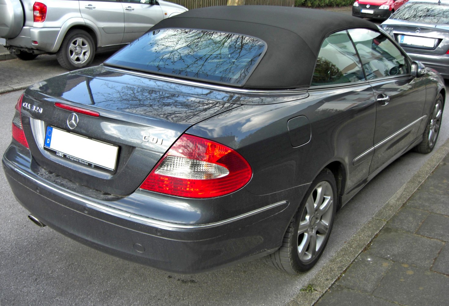 Rear and side view of convertible with soft top and alloy wheels