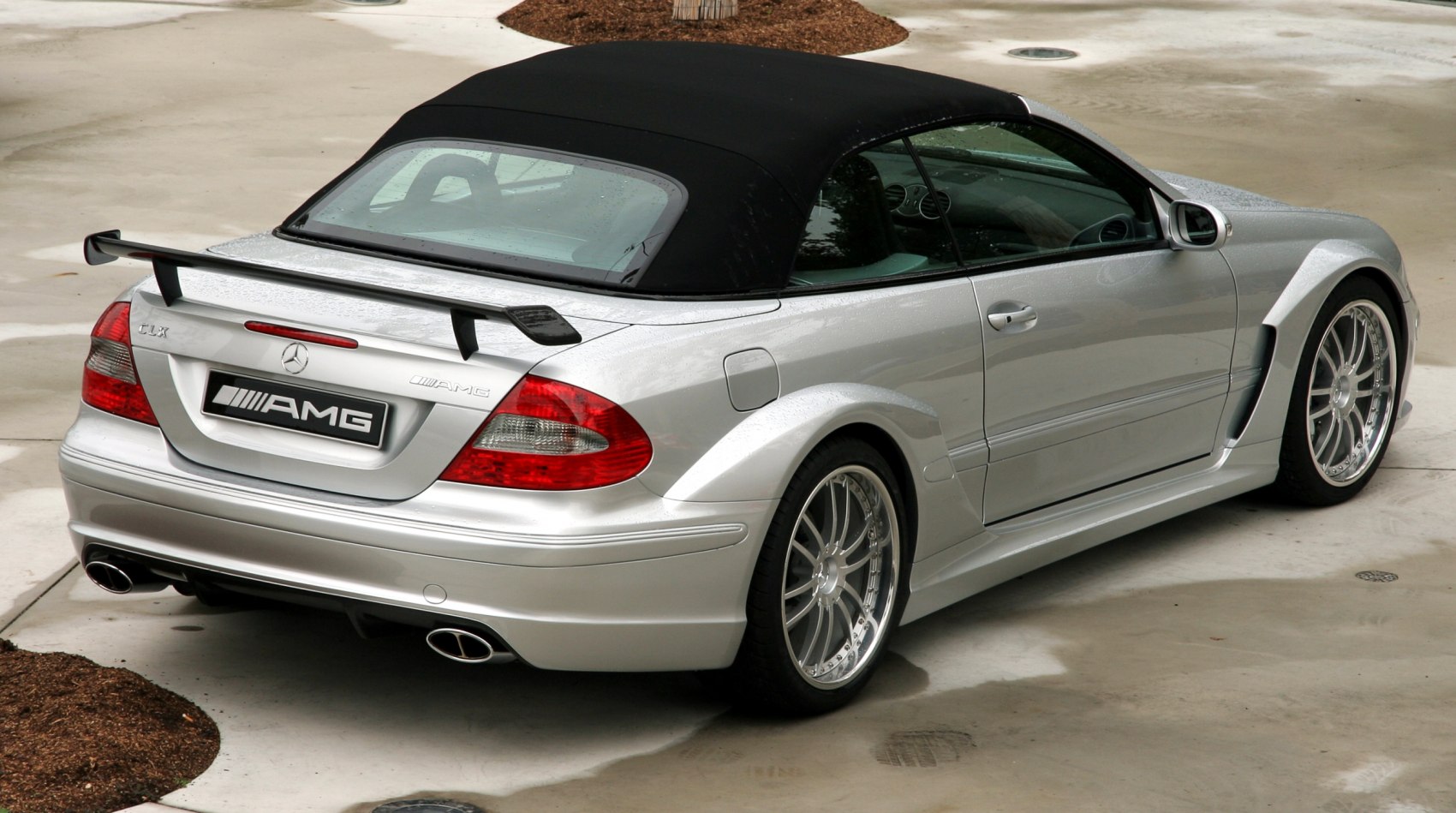 Silver convertible with rear spoiler and dual exhausts