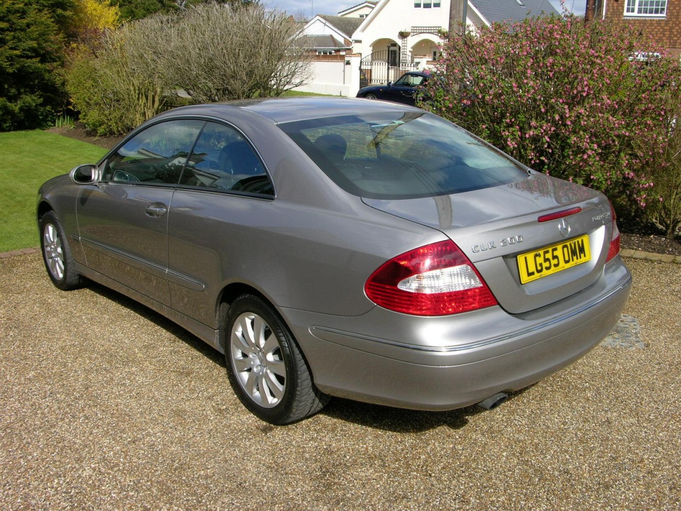 Silver two-door coupe rear and side profile with elegant taillights and alloy wheels