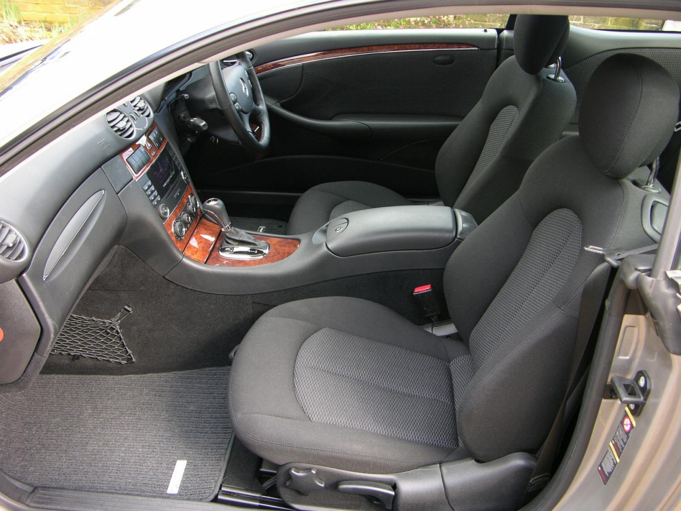 Fabric seats and wood trim interior with dashboard and center console