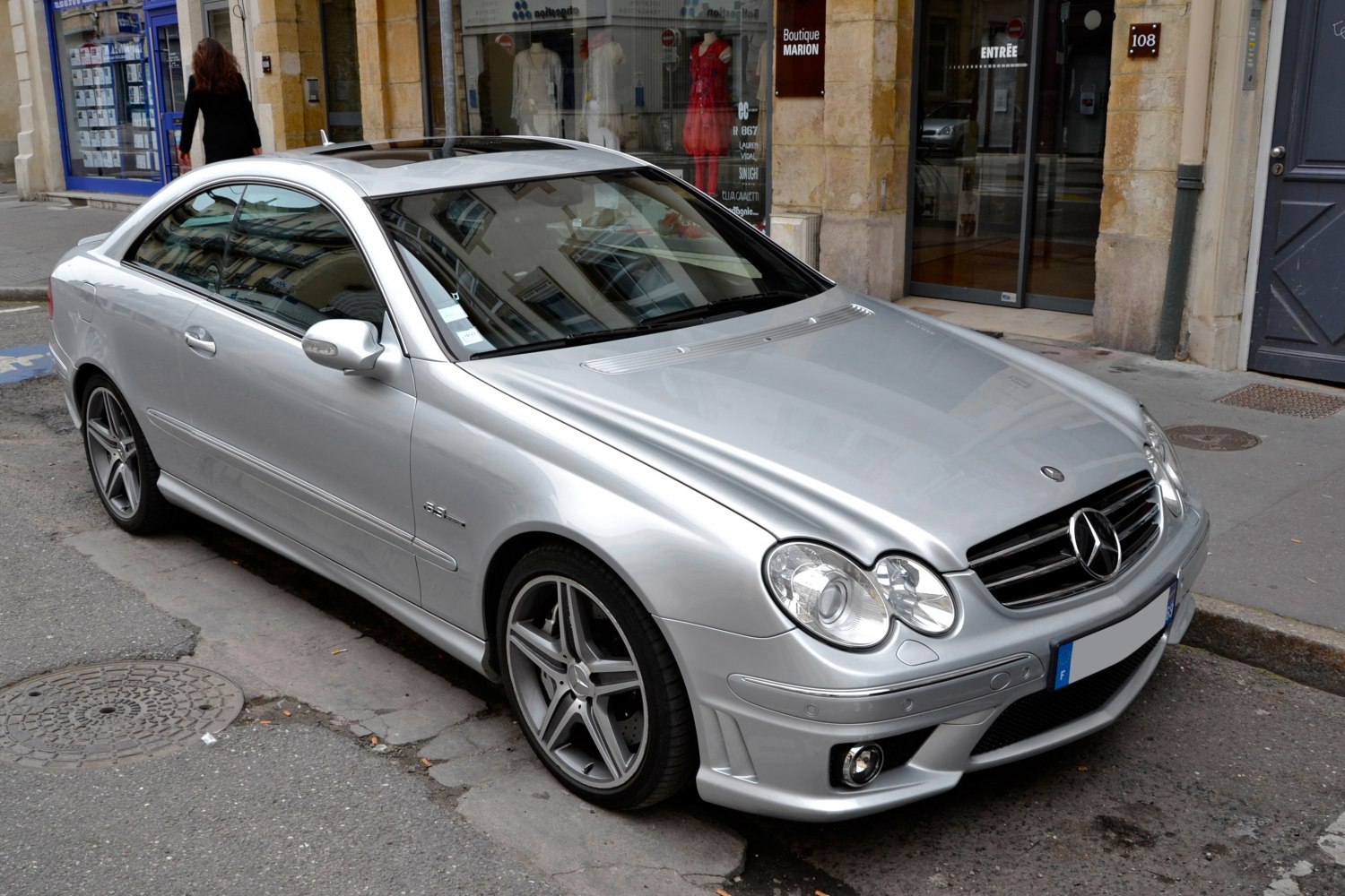 Silver coupe with AMG wheels and dual round headlights