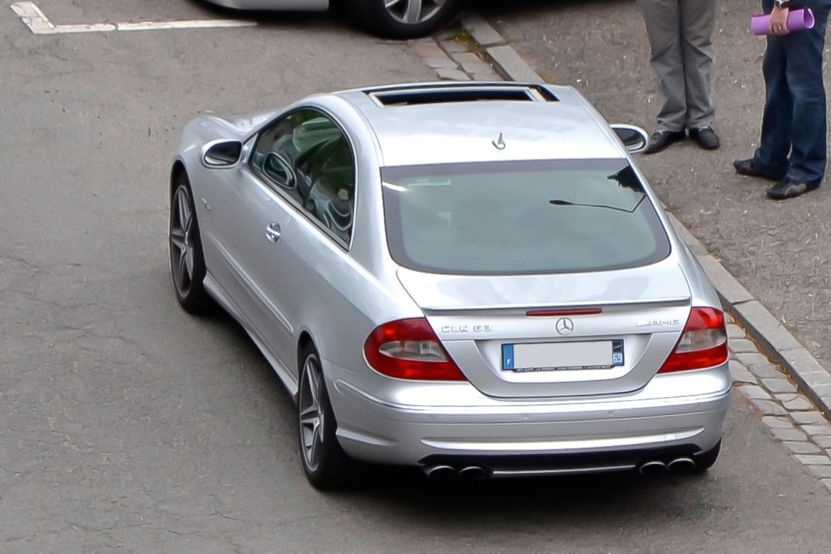 Silver coupe rear view with sunroof and quad exhausts