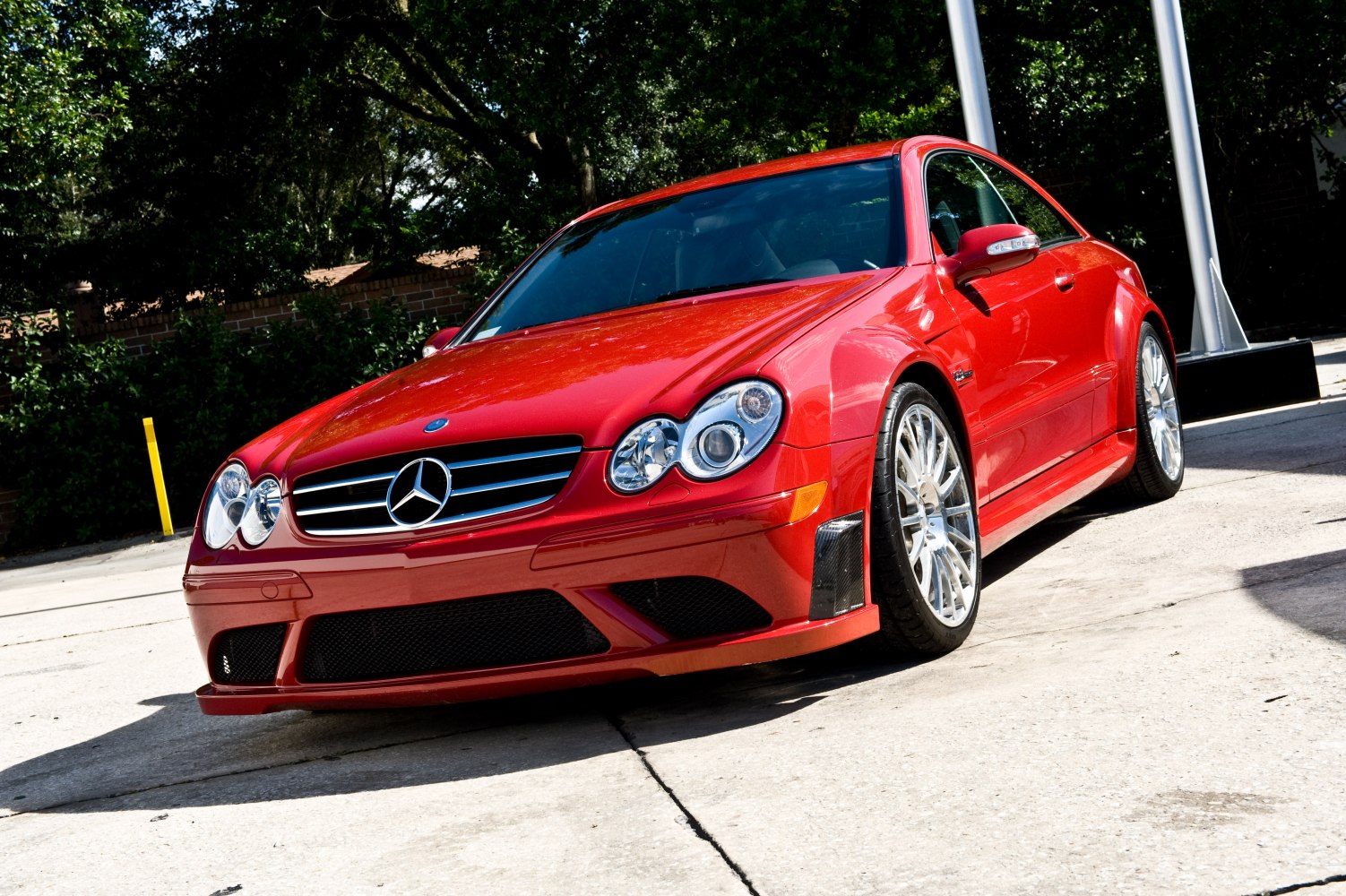 Red coupe with dual round headlights and sporty alloy wheels