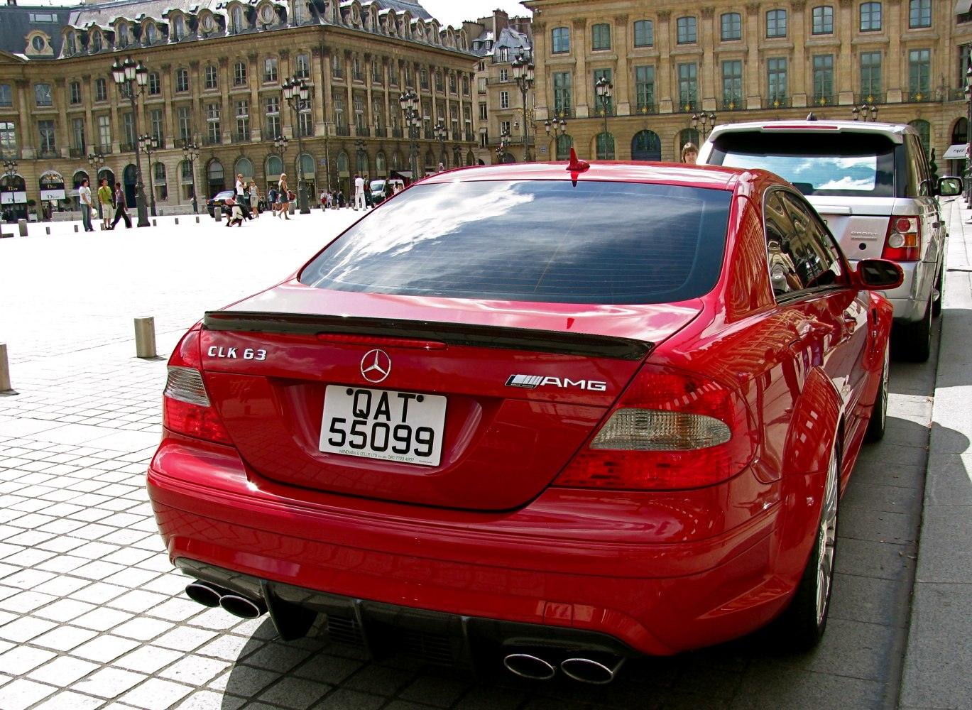 Sleek rear of a performance coupe with quad exhaust and spoiler