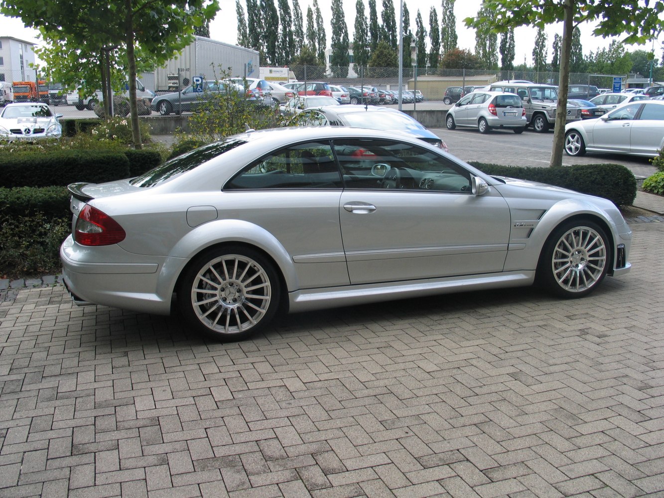 Silver two-door coupe with sporty alloy wheels and sleek side profile