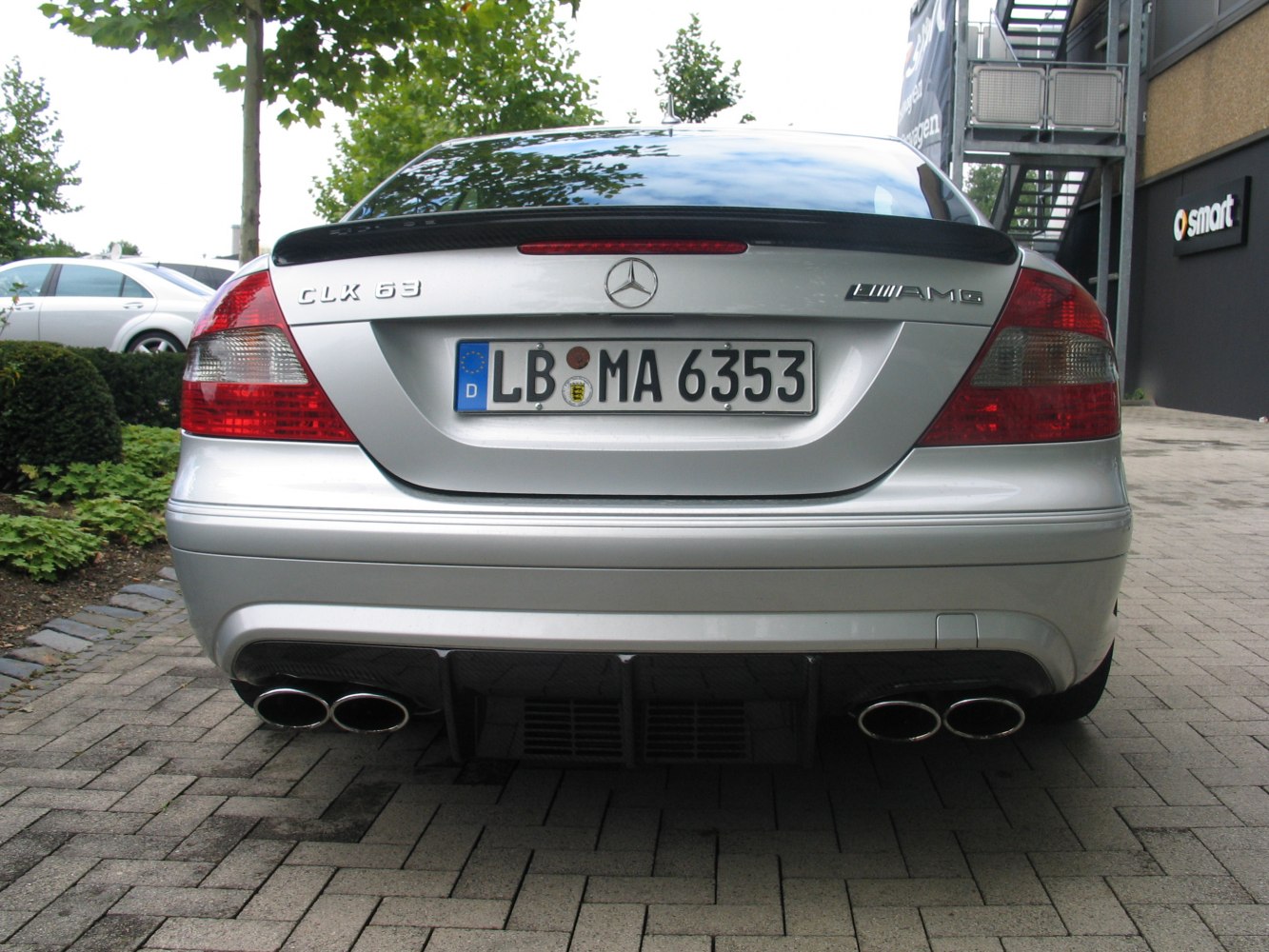 Quad exhaust and rear diffuser on silver sports coupe