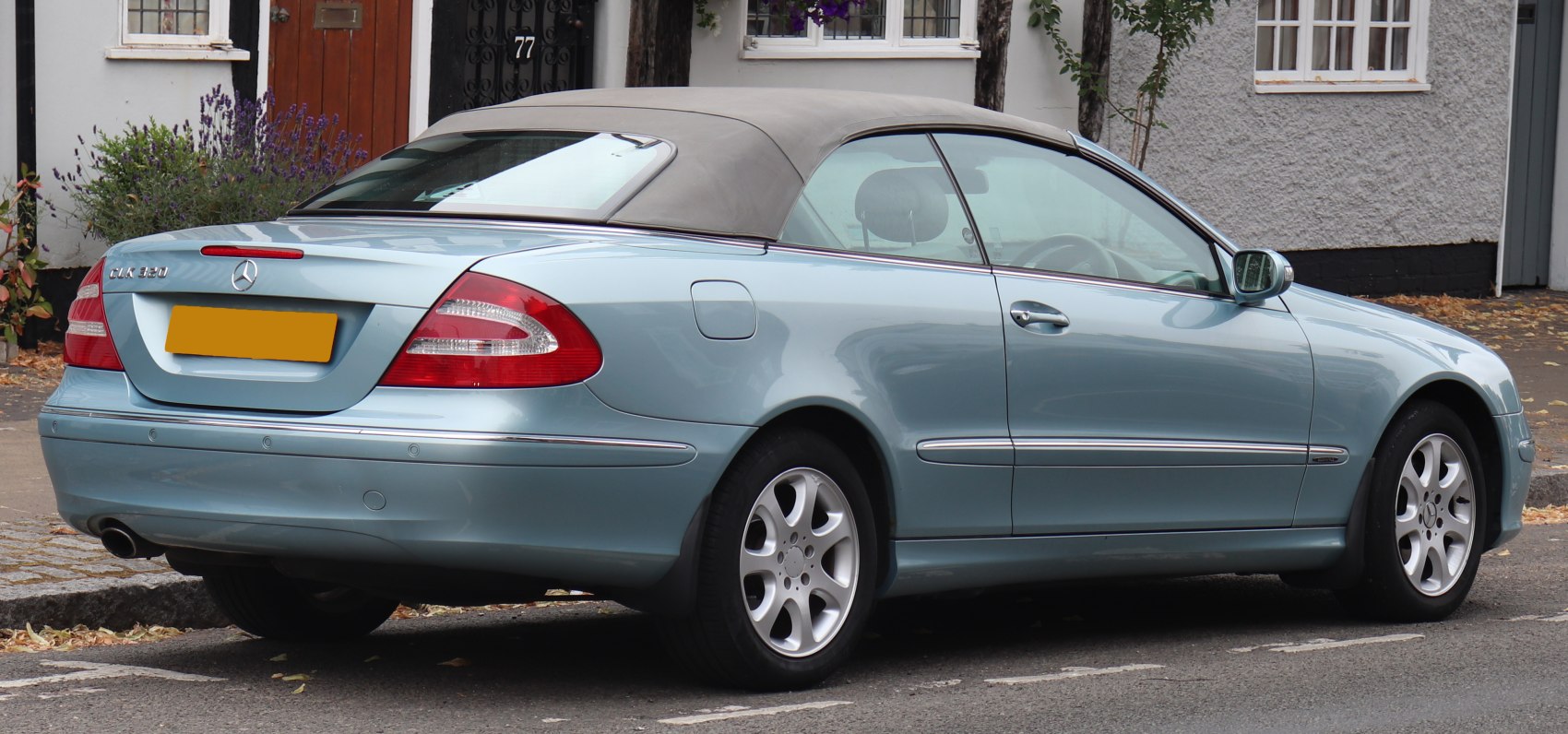 Rear view and soft top convertible of a luxury coupe