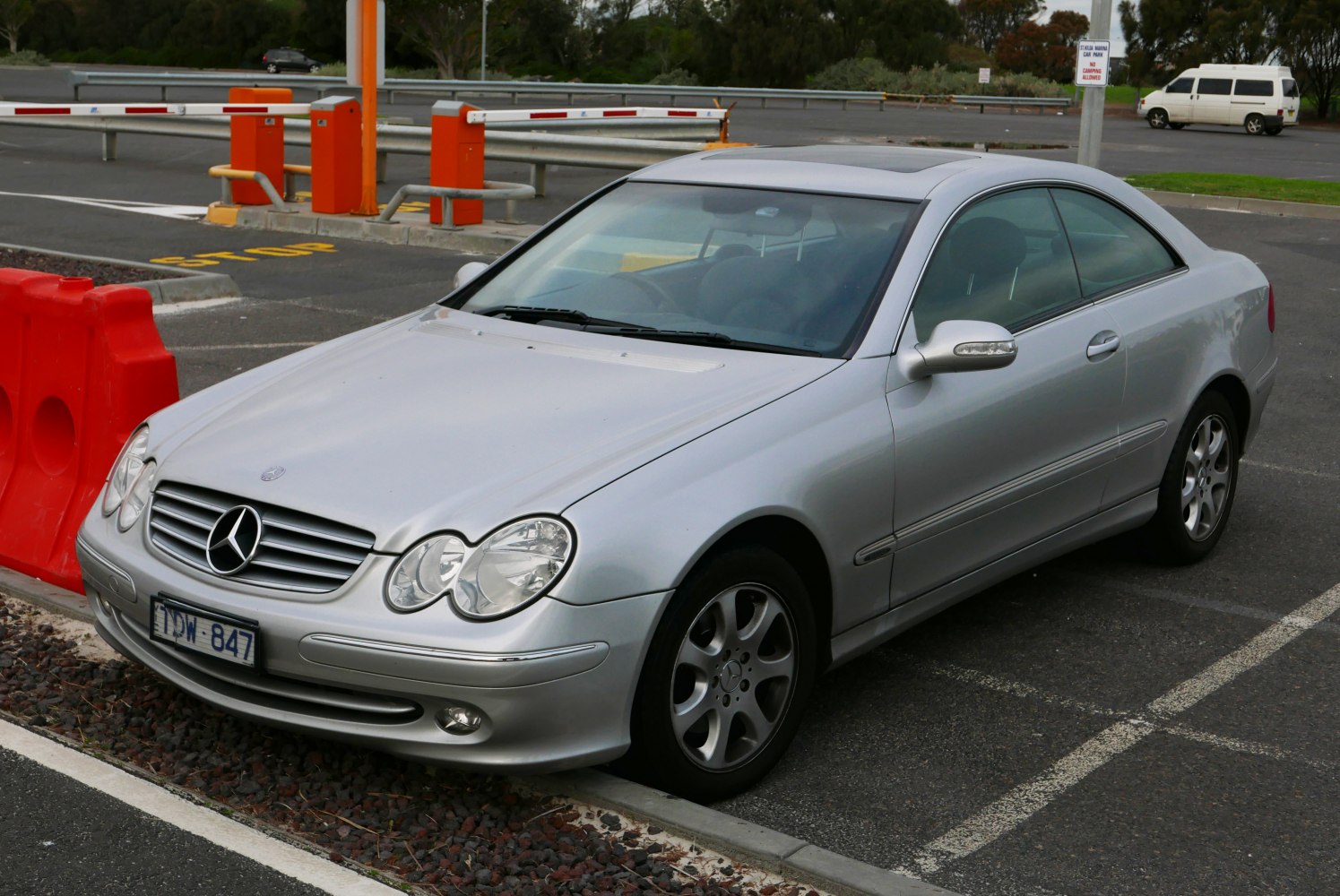 Silver coupe with quad headlights and alloy wheels parked