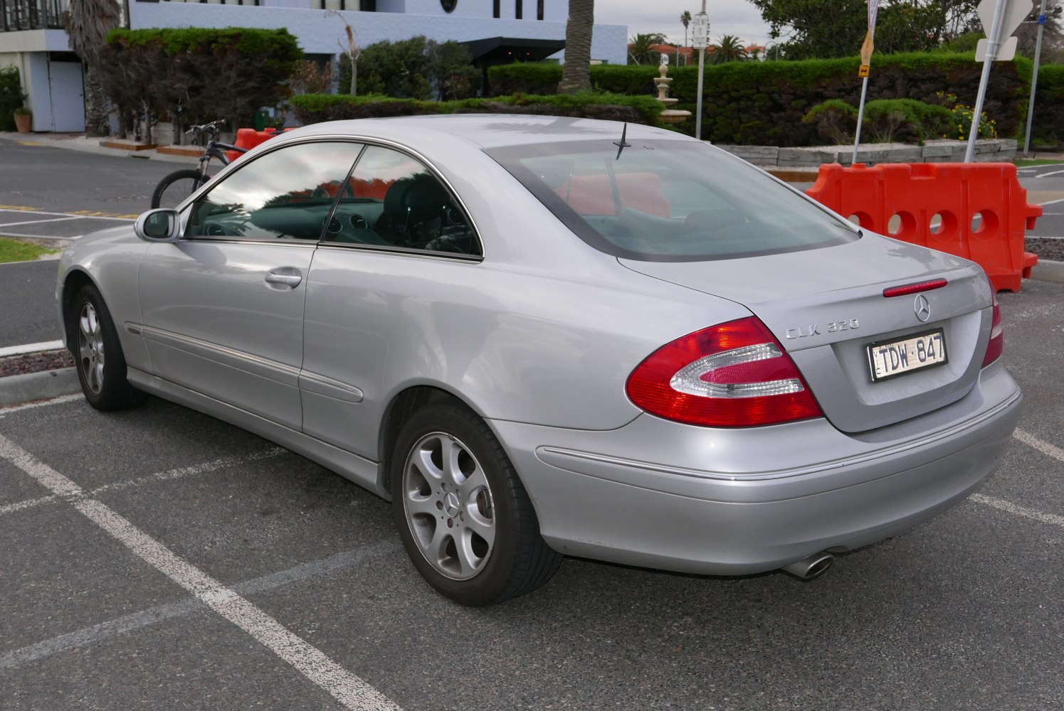 Rear side profile of silver luxury coupe with distinctive taillights and alloy wheels