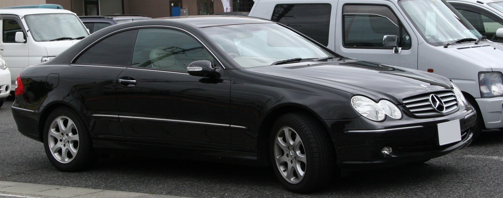 Black two-door coupe with oval twin headlights and alloy wheels