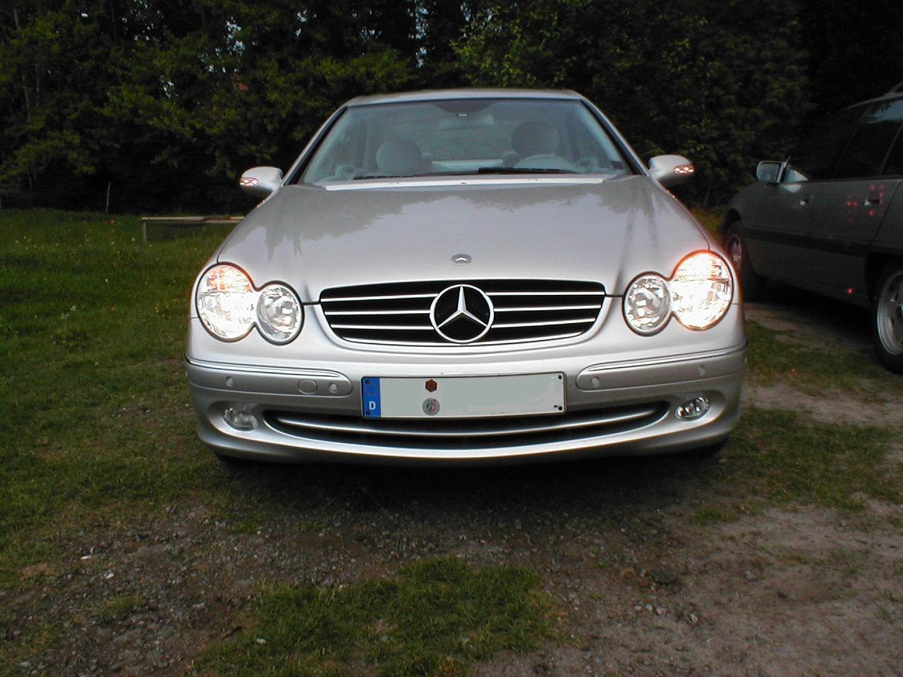 Front view with round dual headlights and classic grille design